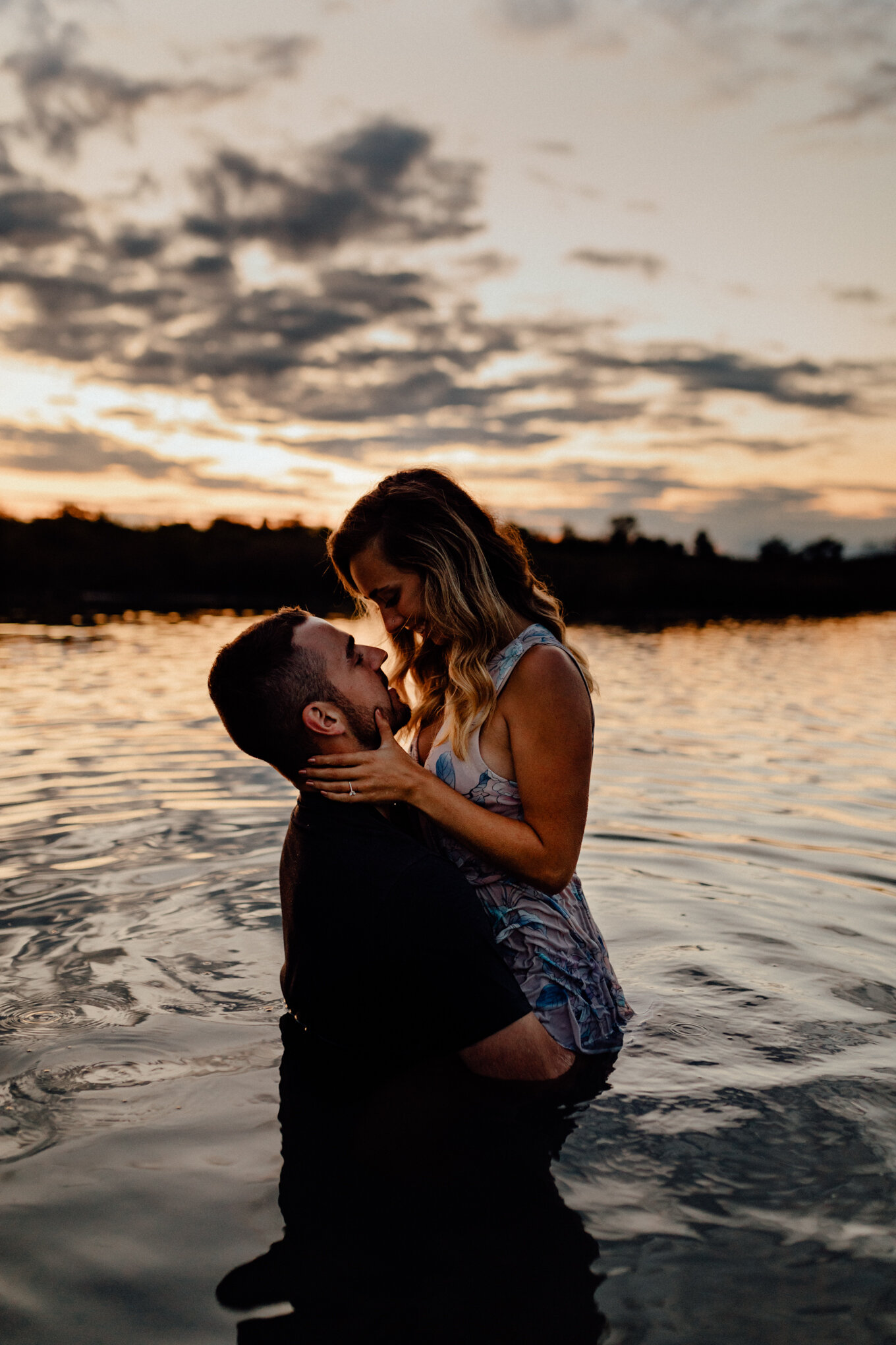  engaged couple in ottawa lake getting close at sunset 