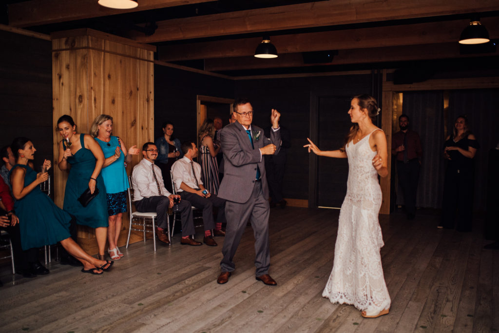 Bride and father do goofy dance for father daughter dance