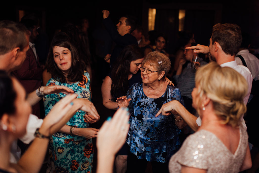 Grandma dancing surrounded by family and hands