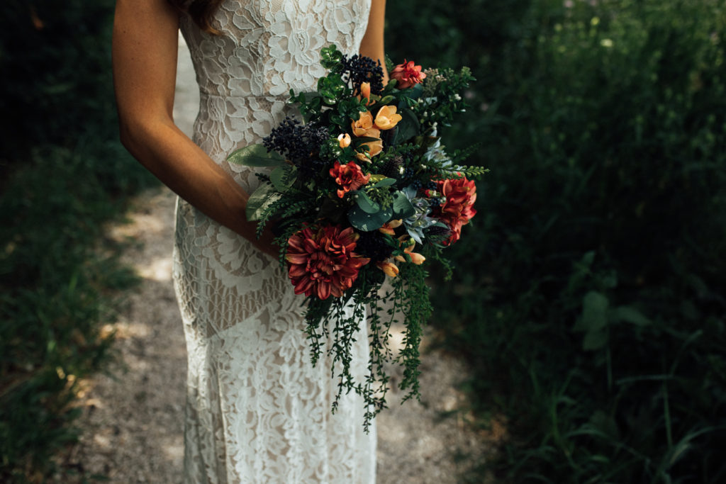 Boho wedding bouquet with dark salmon and peach colored flowers