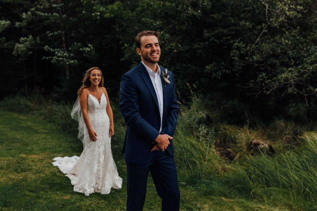 bride giggles behind groom before he turns around for the "first look" and sees her for the first time
