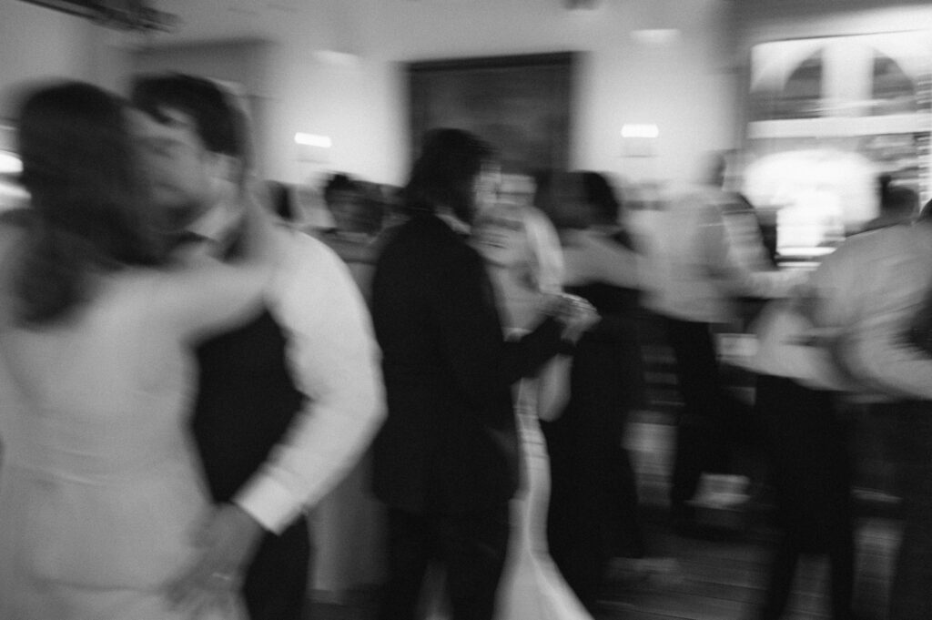 Bride and groom dancing surrounded by wedding guests from their guest list